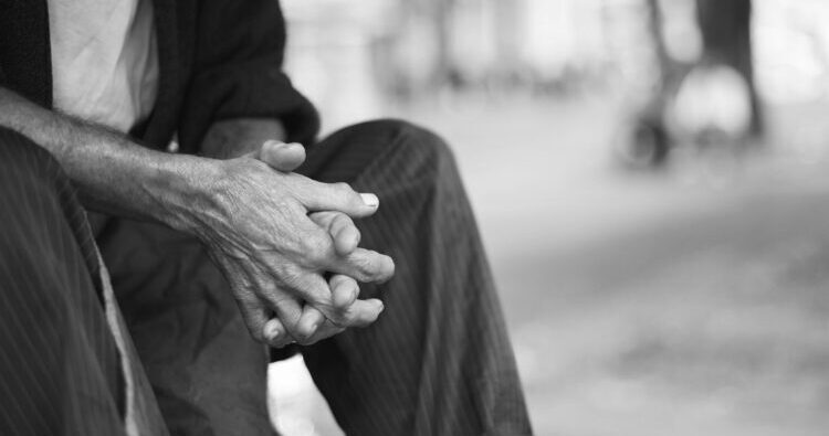 Cropped shot of an old man sitting outside