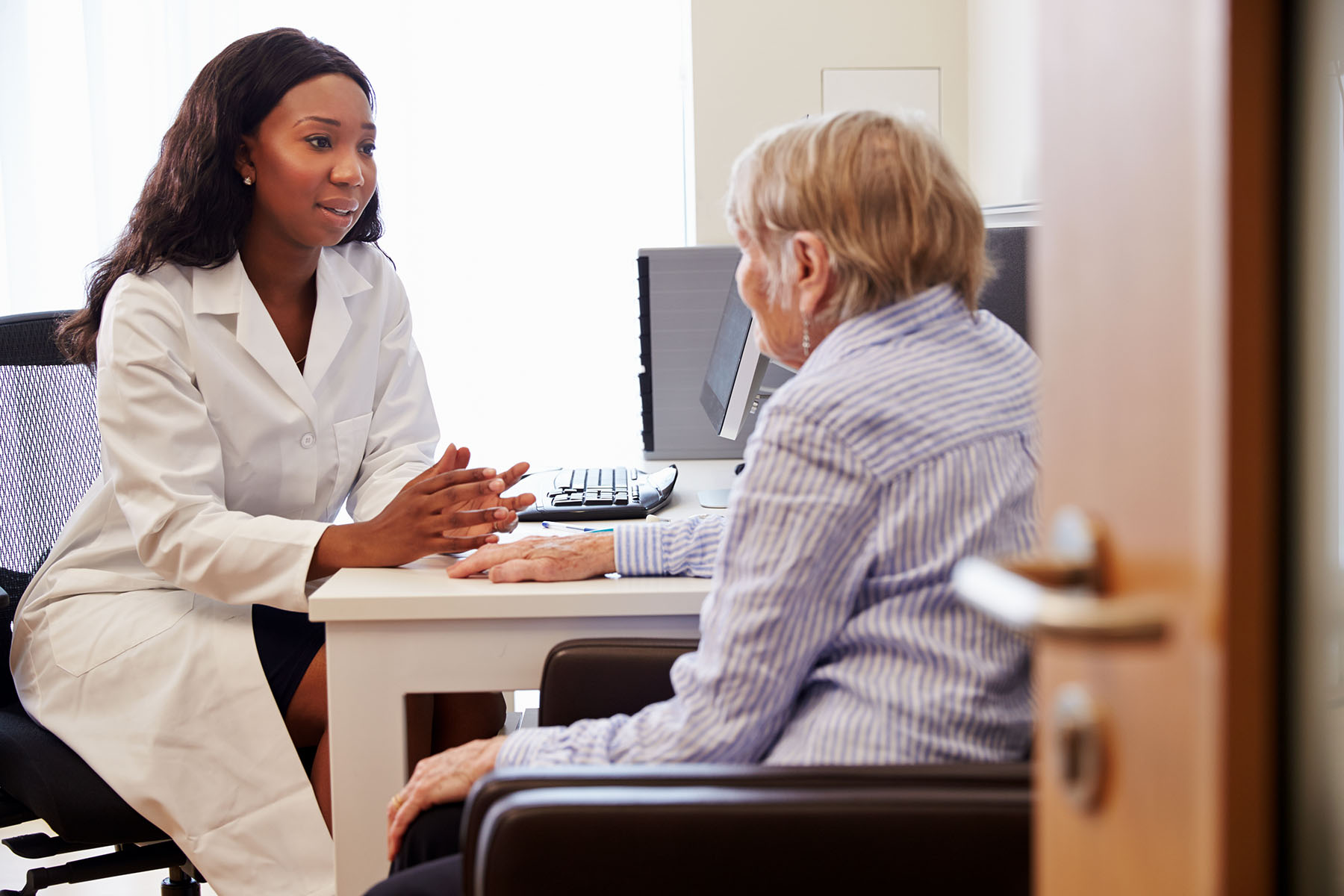 Senior Patient Having Consultation With Doctor In Office