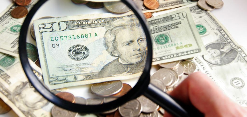 Magnifying glass over money shows DC can find more revenue for the DC budget