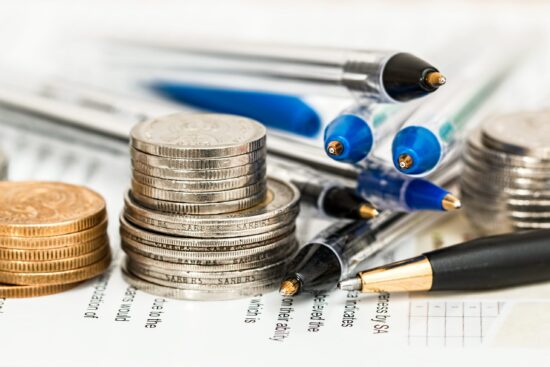 image of coins, pens, and a budget sheet