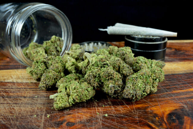 Photo of cannabis on a wooden desk