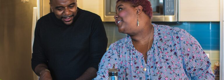 Black man and Black woman at a kitchen sink