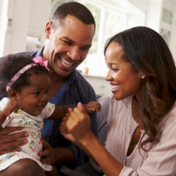 Parents smiling with baby