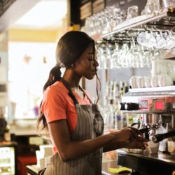 Woman Preparing Coffee latte Near Espresso Machine