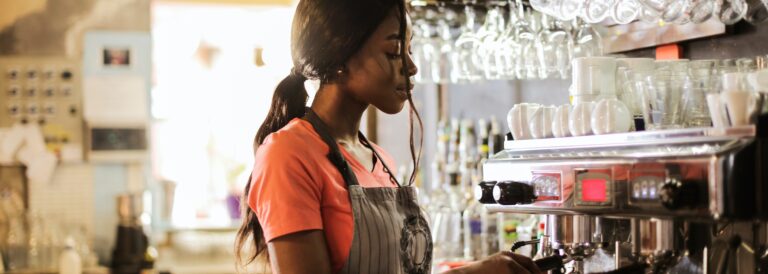 Woman Preparing Coffee latte Near Espresso Machine