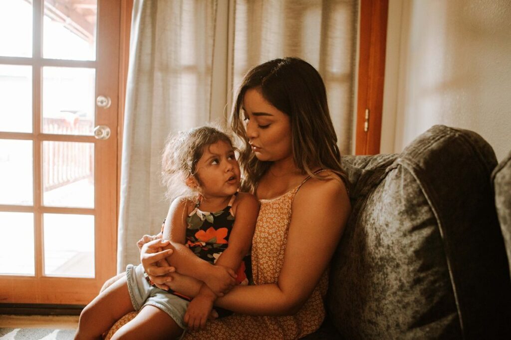 child sitting on mother's lap