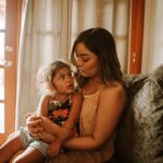 child sitting on mother's lap