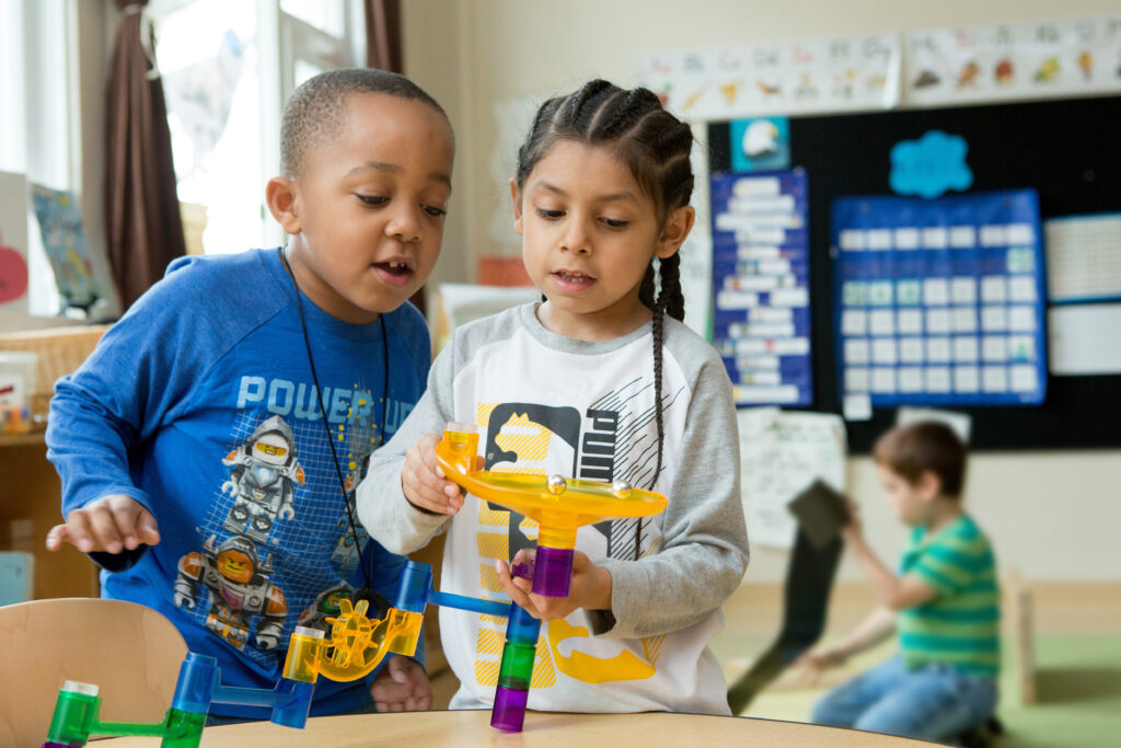 Kindergarteners build a marble run inspired by a lesson about movement.