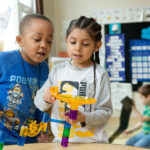 Kindergarteners build a marble run inspired by a lesson about movement.