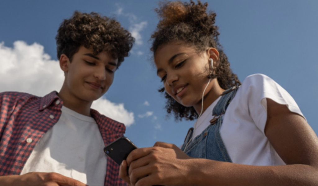 Two teenagers with blue sky in the background