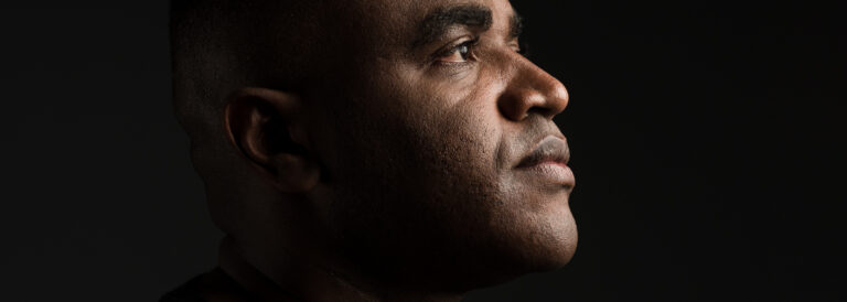 the profile of a black man in a black t-shirt