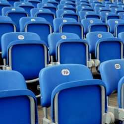 Empty blue chairs in a sports stadium