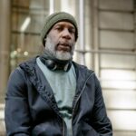 Elderly Black man wearing a beanie and sweatshirt