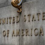 stained sign that reads United States of America